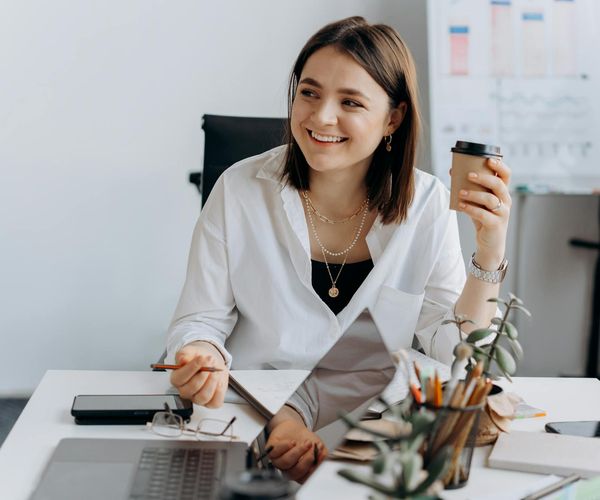Person feeling refreshed while working at a modern office desk, suggesting a break from sedentary work.